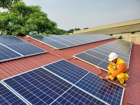 A solar technician performs maintenance on rooftop solar panels enhancing energy efficiency. reduz