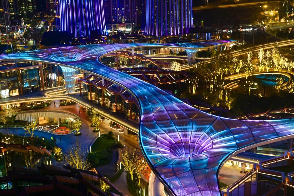 A dazzling night view of futuristic architectural design with glowing lights.