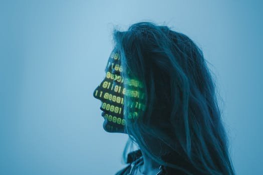 Silhouette of a woman with binary code projected on her face in a digital concept setting. Wearables