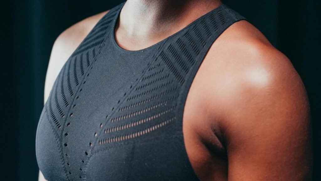 Detailed close-up of a person wearing a black sports bra, focusing on the texture and design.